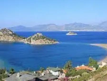 Datça İlçesi Kızlan Mevkisinde Denize Sıfır 10000M2 Turizm İmarlı Denize Sıfır Otel Yapımına Uygun Satılık Arsa